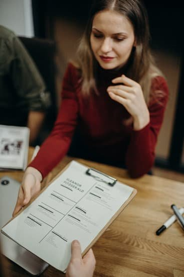 A woman being handed a clipboard