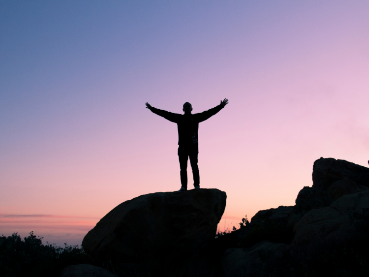 A man stood on a rock in the countryside