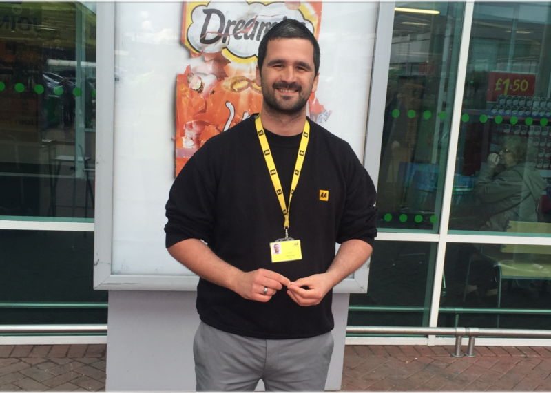 A man working for the AA smiling