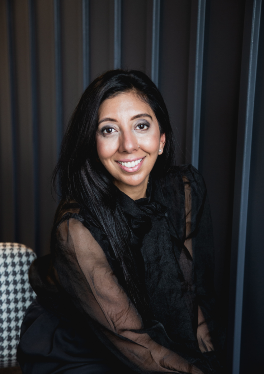 Leena Parmar smiling sat down