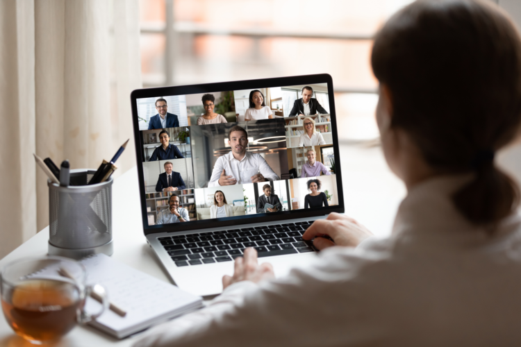 A woman sat on her laptop in a virtual meeting