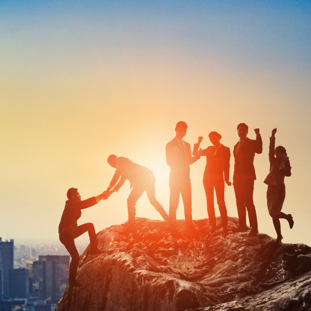 A group of people atop a mountain
