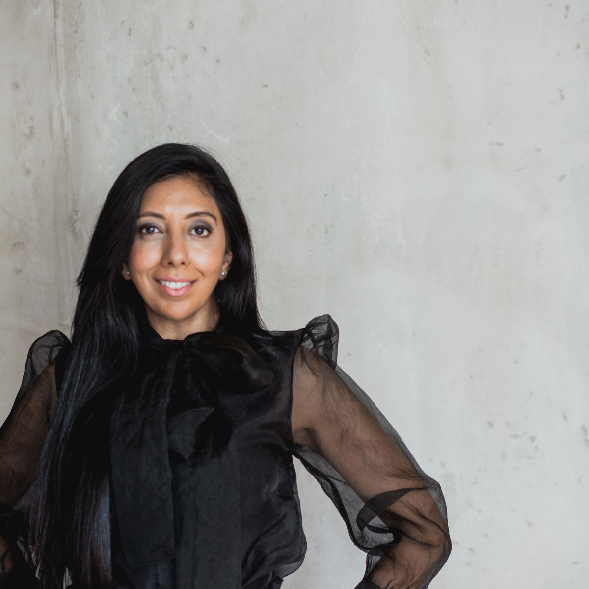 Leena Parmar in a black dress