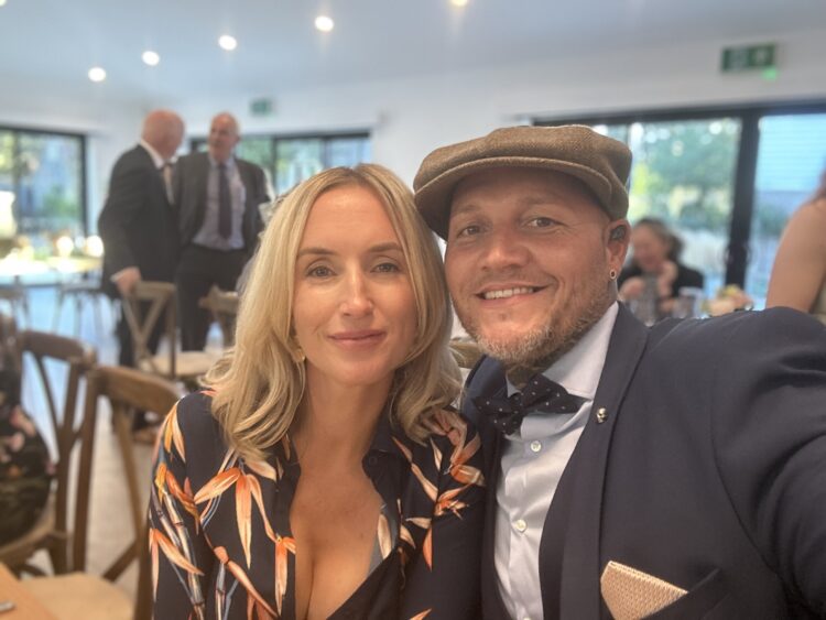 A man and a woman taking a selfie at a corporate event