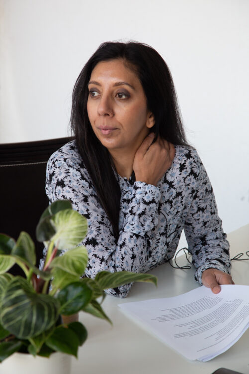 Leena Parmar looking into the distance while holding a piece of paper