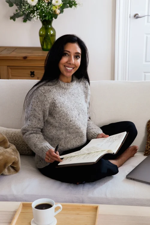 Leena Parmar sat cross-legged on a sofa making notes