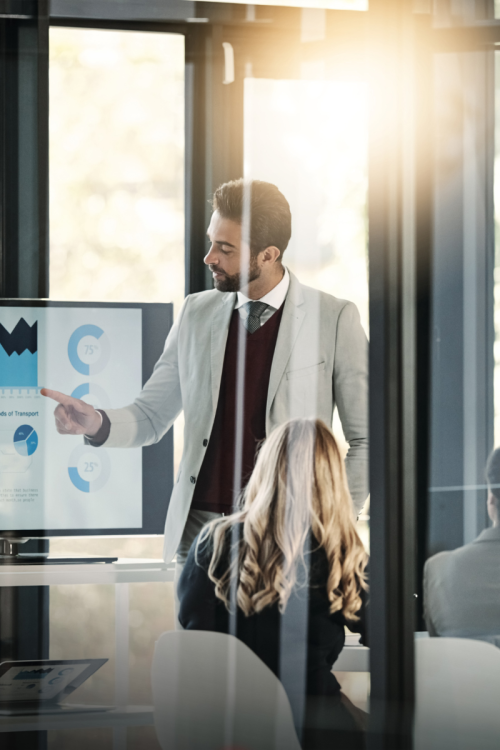 A salesman presenting statistics in an office