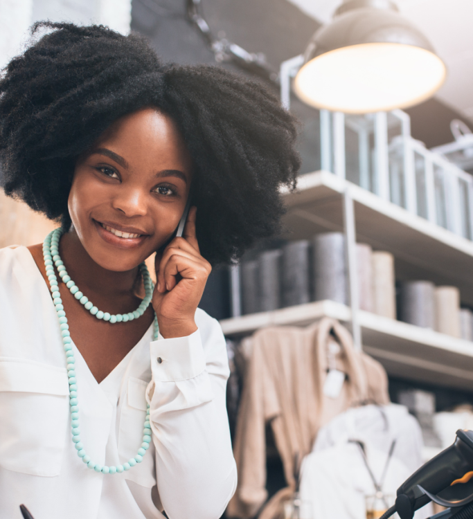 A smiling sales professional on the phone