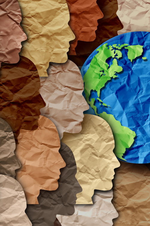 Colourful paper cut outs of faces and a world map.