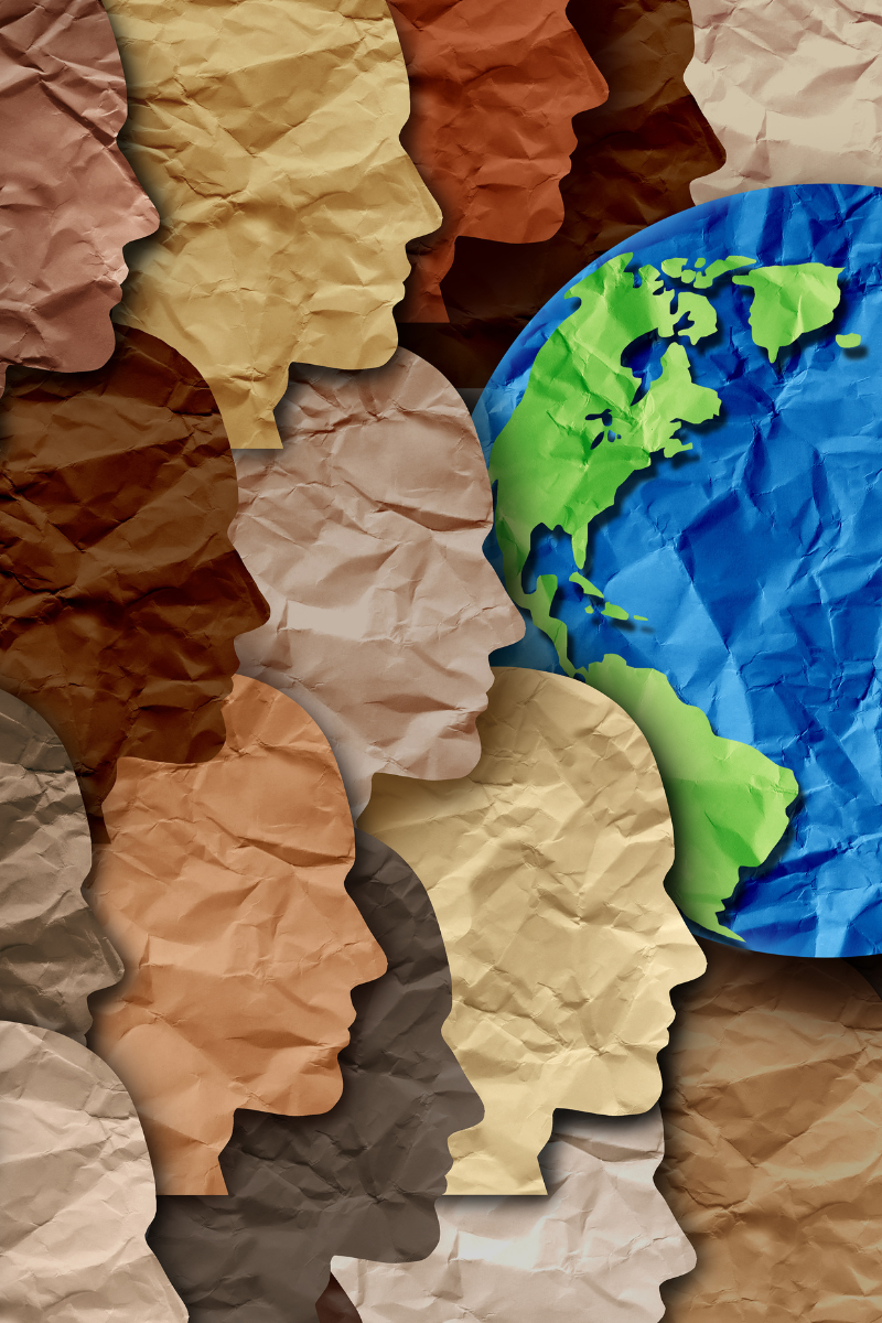 Colourful paper cut outs of faces and a world map.